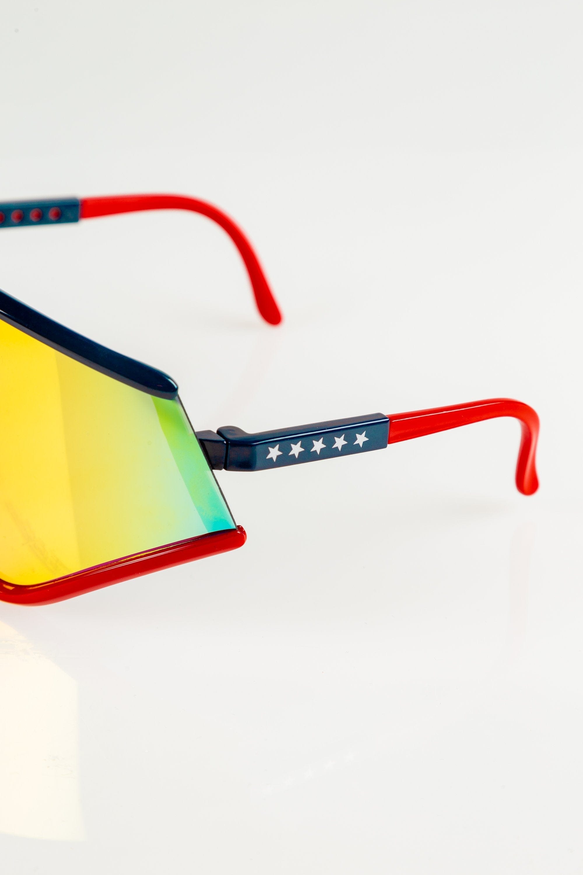 The Cornea Combusters | Red And Blue Revo Retro Macho Sunglasses - Shinesty