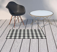 2' X 4' Black and Ivory Indoor Outdoor Area Rug